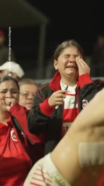 Emotional Dragons supporters get a lucky souvenir from the Captain, Jack de Belin.