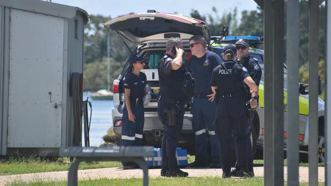 Police investigate the scene on the banks of the Burnett River and interview boaties following a serious boat crash.