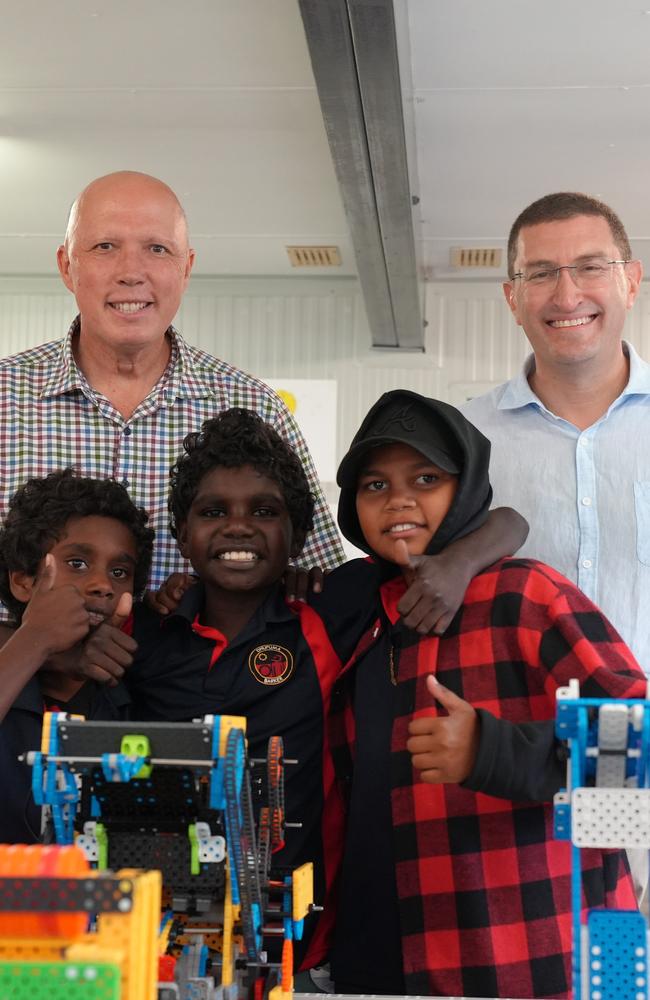 Opposition Leader Peter Dutton during a visit to Dhupuma Barker School in Northeast Arnhem Land in the Gove Peninsula, with students Sean Yunupingu, Justin Yunupingu and Cyrus Marika. Picture: Matt Cunningham