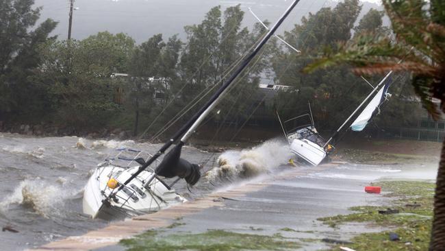 Yachts washed up on Gosford waterfront in rough seas. Picture: Mark Scott