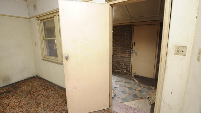 Old carpet, tired walls and cobwebs are all that exist in the living room. Picture: Phil Rogers