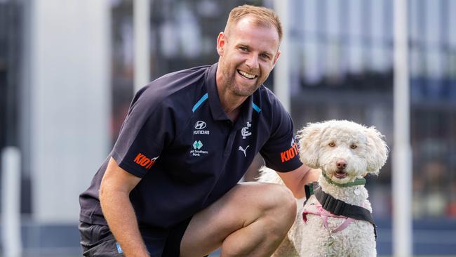 Sam Docherty with Pebbles, 2 year old labradoodle Animal Assisted Education Therapy Dog. Carlton footballer Sam Docherty is donating $30,000 to Peter Mac for cancer research and $10,000 to McKillop Family Services. It is from his Jim Stynes award - Sam had cancer and will be pictured with a 23-year-old Blues fan Liam Contarin who was diagnosed with the same cancer around the same time. Picture: Jason Edwards