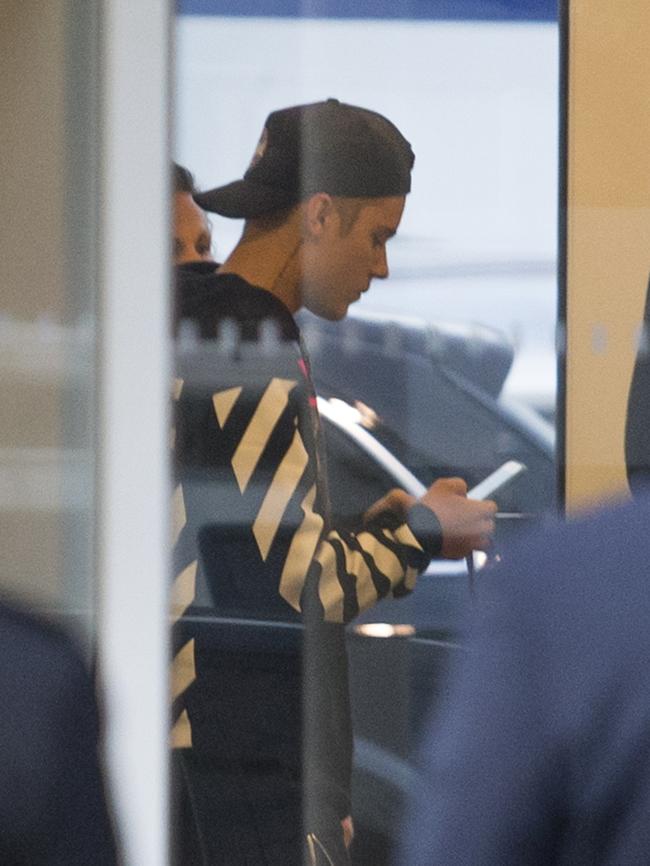 Justin Bieber disembarks in Sydney with his entourage to visit Hailey Baldwin. Picture: Splash