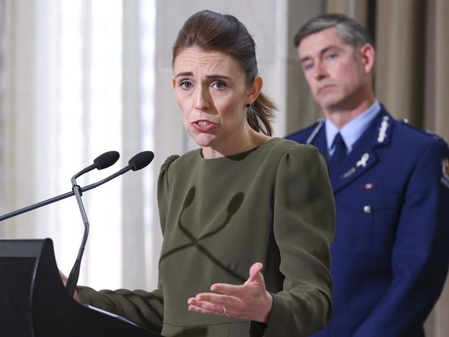 WELLINGTON, NEW ZEALAND - DECEMBER 08: Prime Minister Jacinda Ardern speaks while Police Commissioner Andrew Coster looks on during a media lock-up ahead of the release of the Royal Commission of Inquiry in relation to the Terrorist Attack on Christchurch Mosques at Parliament on December 08, 2020 in Wellington, New Zealand. The Royal Commission report into the 2019 terrorist attack on Christchurch mosques will be released on Tuesday 8 December.  51 people were killed after a man opened fire at Al Noor Mosque and the Linwood Islamic Centre in Christchurch on Friday, 15 March 2019. The Australian gunman was sentenced to life in prison without parole after being found guilty of 92 charges relating to what was New Zealand's worst mass shooting in history. (Photo by Hagen Hopkins/Getty Images)