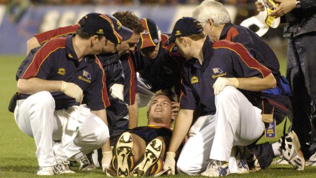 Rhett Biglands is taken from the field after a bump from Byron Pickett in 2005.
