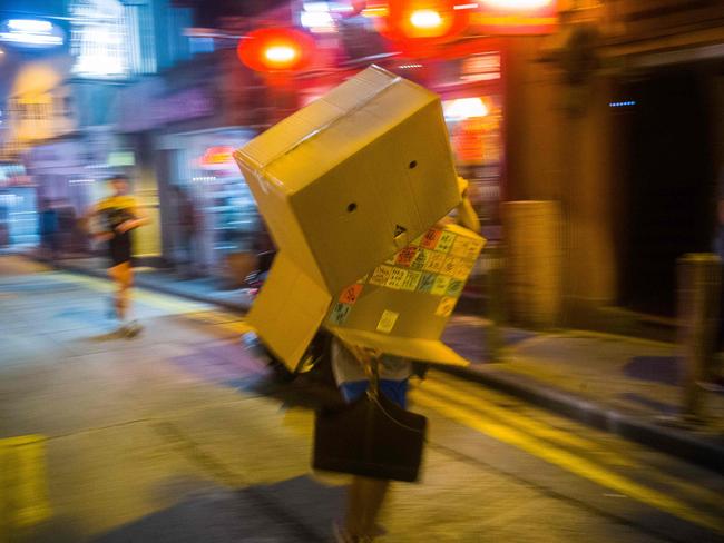 A man wearing a costume depicting a “Lennon Wall” takes part in a Halloween themed run in Hong Kong. Picture: AFP