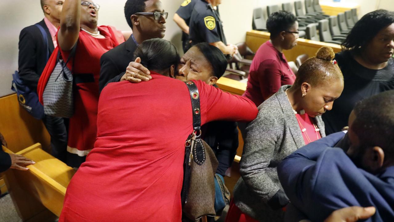 Members of Mr Jean's family embrace in the courtroom. Picture: Tom Fox/The Dallas Morning News via AP