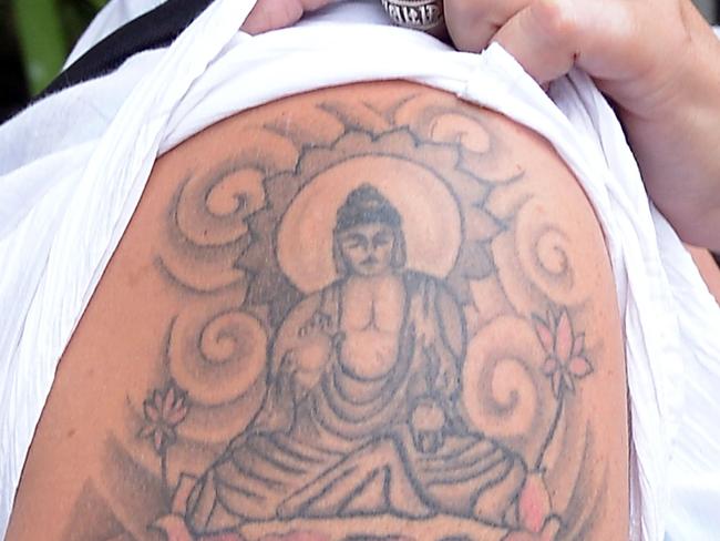 (FILES) This file photo taken on April 22, 2014 shows British tourist Naomi Coleman posing for a photograph to display a tattoo of the Buddha on her upper arm, after she was arrested at Sri Lanka's main international airport and later ordered with deportation for having a tattoo of the Buddha, in Colombo. Sri Lanka's top court on November 15 awarded compensation to a British woman arrested for sporting a Buddha tattoo, saying the nurse was subjected to "horrifying and scandalous treatment" by local authorities. Naomi Michelle Coleman was detained in prison in 2014 after touching down in Colombo, where police in the Buddhist-majority country took offence to the tattoo on her arm.  / AFP PHOTO / Lakruwan WANNIARACHCHI