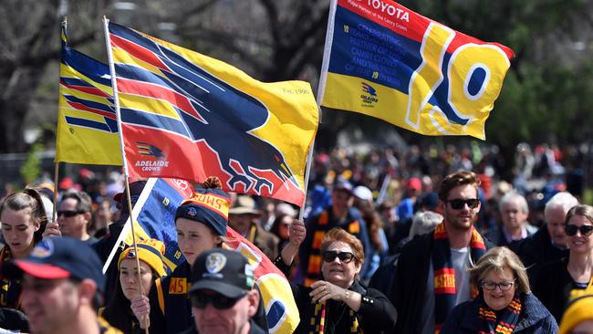 Adelaide Crows fans march to the MCG for the 2017 AFL Grand Final against Richmond.