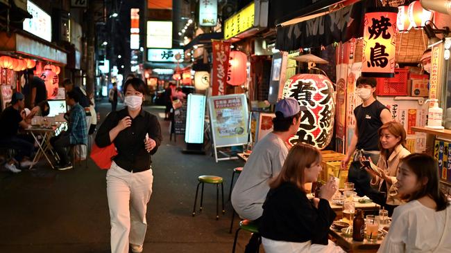 People gather at a Japanese-style bar in Tokyo. Picture: AFP