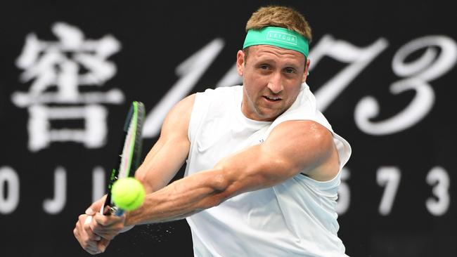 Tennys Sandgren hits a return against Italy's Fabio Fognini.