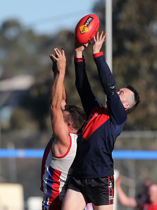 Swifts Creek’s Jesse Hack marks over Lindenow South’s Russell White. Picture: Yuri Kouzmin