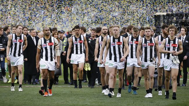 Collingwood players leave the MCG as West Coast celebrates. Picture: David Caird