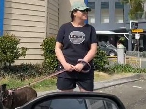 A TikTok video has gone viral showing a middle-aged woman, dubbed a "Karen", standing in front of a car park with a dog to reserve it for her husband.Frame grab from Tik Tok  user @marlimclaren: