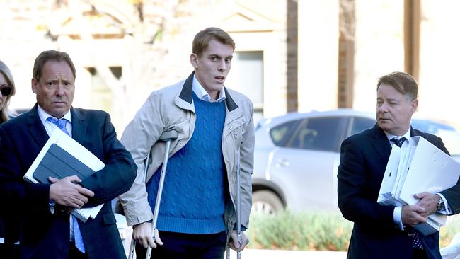 Harrison Kitt, centre, arrives at the Adelaide Magistrates Court flanked by his defence barrister David Edwardson QC and solicitor Matthew Selley. Picture: Tricia Watkinson