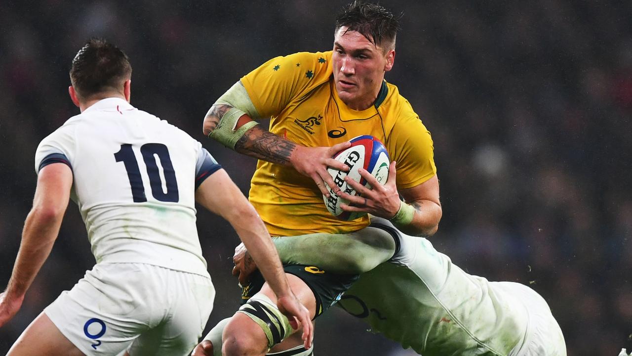 Sean McMahon of Australia is tackled by Courtney Lawes of England.