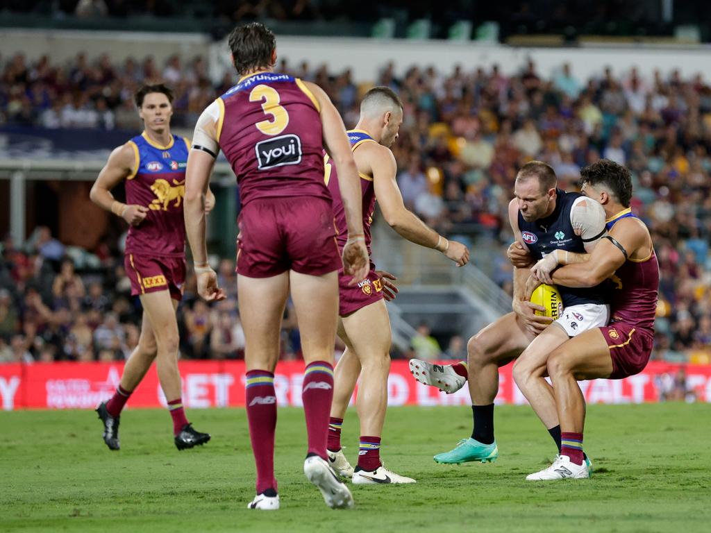 Carlton's Sam Docherty (second from right) is tackled by Lions star Cam Rayner at the Gabba. Picture: Russell Freeman/AFL Photos via Getty Images