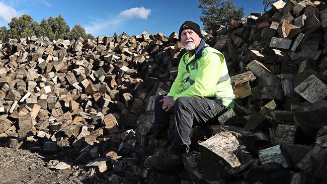 Mark Brown, from Firewood To U, whose stockpile is slowy shrinking after his supply from Ta Ann mill stopped. Picture: LUKE BOWDEN