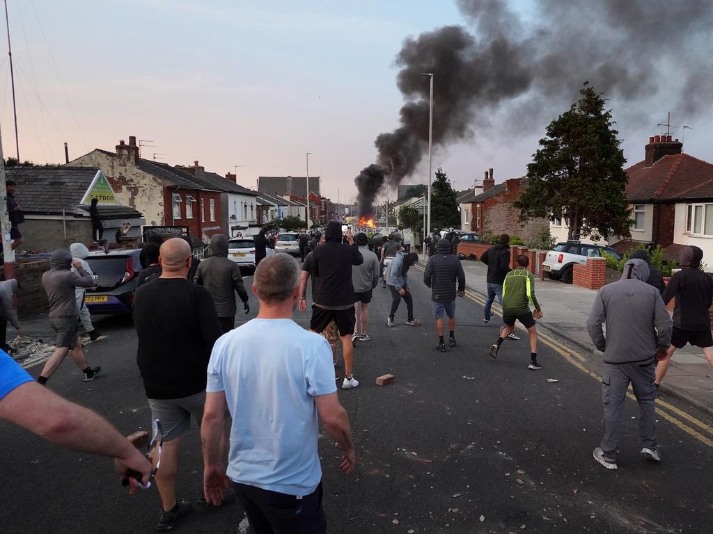 Protesters hurl projectiles at police in Southport. Picture: Getty Images