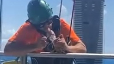 A video emerged on TikTok showing a tradie smoking a bong while suspended from a tower at Surfers Paradise on the Gold Coast. Picture: TikTok/Supplied