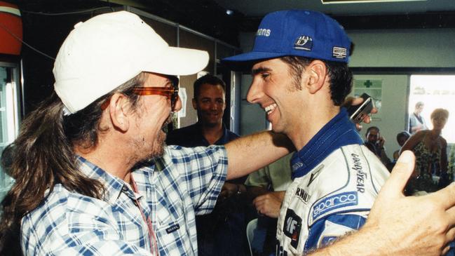 British musician and Grand Prix fan George Harrison hugs Williams-Renault racing driver Damon Hill after he won the Australian Formula One Grand Prix, the last held at the Adelaide street circuit, in 1995.