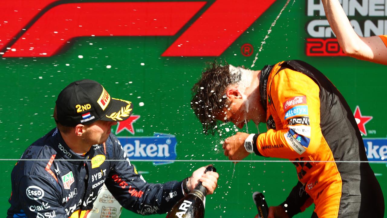 ZANDVOORT, NETHERLANDS - AUGUST 25: Race winner Lando Norris of Great Britain and McLaren celebrates with second placed Max Verstappen of the Netherlands and Oracle Red Bull Racing in parc ferme after the F1 Grand Prix of Netherlands at Circuit Zandvoort on August 25, 2024 in Zandvoort, Netherlands. (Photo by Joe Portlock/Getty Images)