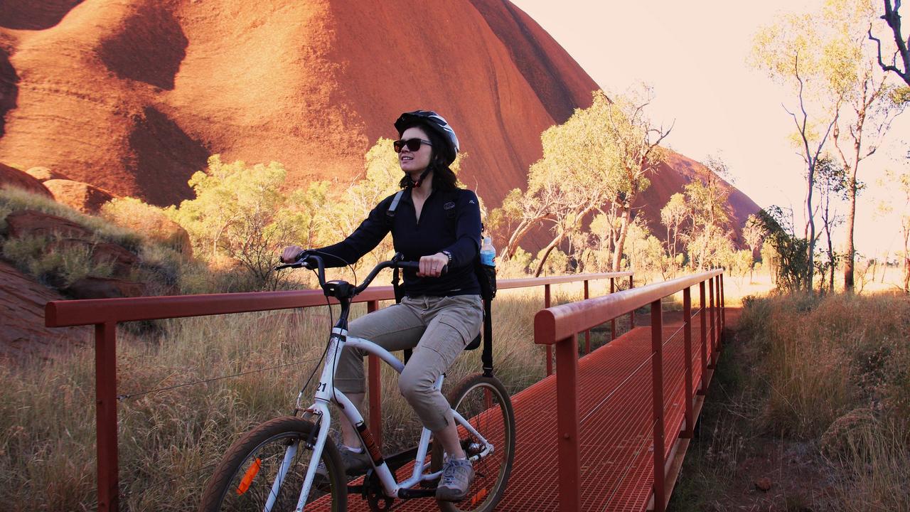 Tourists can enjoy a bicycle ride around Uluru. Picture: Tourism NT