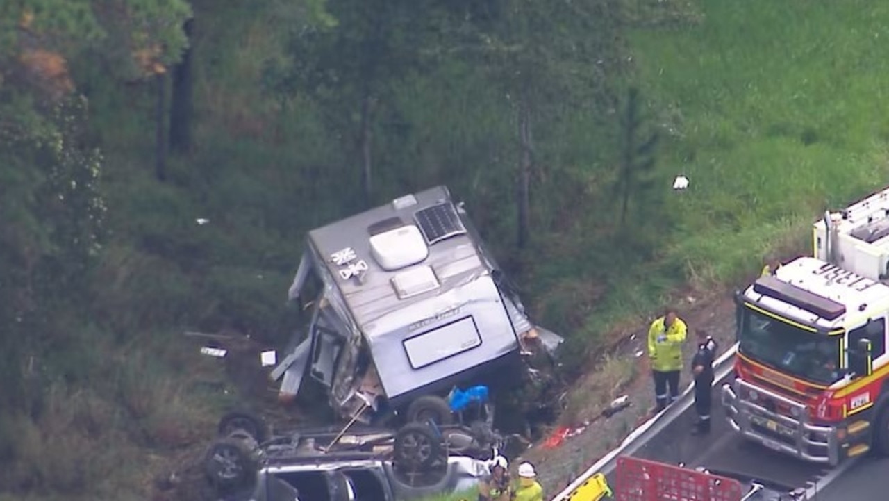 A car towing a caravan has crashed and rolled down an embankment on the Bruce Highway.