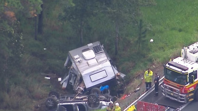 A car towing a caravan has crashed and rolled down an embankment on the Bruce Highway.