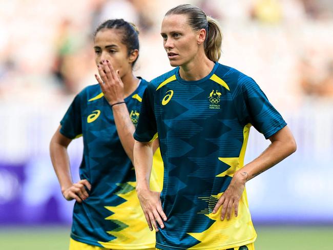 Australia's midfielder #10 Emily Van Egmond (C) looks on as her team warms up before the women's group B football match between Australia and Zambia during the Paris 2024 Olympic Games at the Nice Stadium in Nice on July 28, 2024. (Photo by Valery HACHE / AFP)