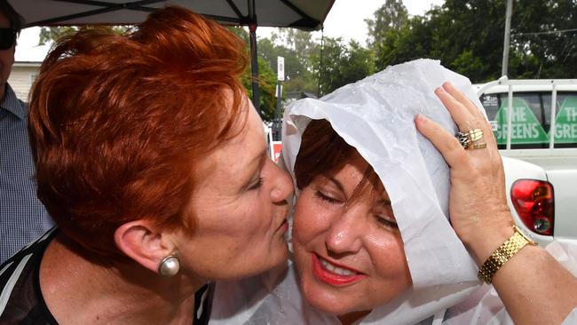 One Nation leader Senator Pauline Hanson (left) and ALP member for Bundamba, Jo-Ann Miller (right) are seen together in the suburb of Bundamba in Ipswich during the Queensland Election campaign on Tuesday, November 21, 2017. Senator Hanson is campaigning in the electorate of Bundamba currently held by the ALP's Jo-Ann Miller. (AAP Image/Darren England) NO ARCHIVING