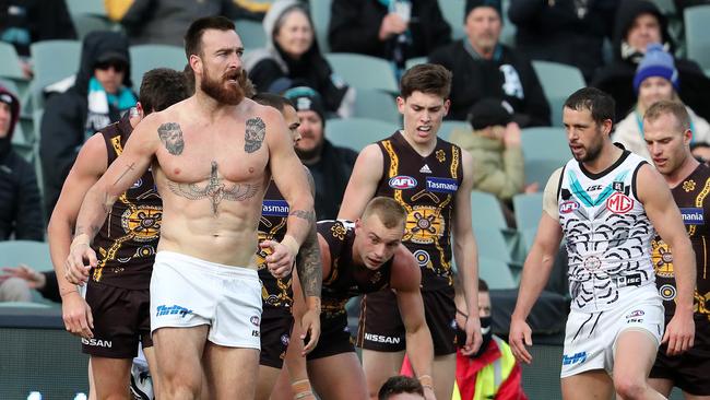 The Adelaide spectators went berserk after star forward Charlie Dixon emerged from a melee without a jersey and his impressive rig on display.