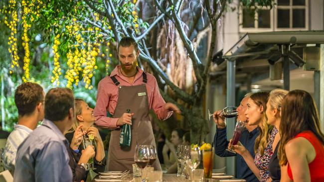 A waiter serves customers at Char Restaurant, one of four distinct function spaces hosted in the Old Admiralty House building. Picture: Nick Pincott