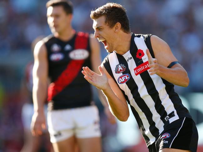 Adam Oxley celebrates a goal for Collingwood during the 2016 AFL Anzac Day match against Essendon.