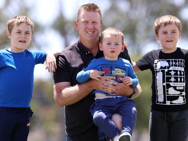 Walk for the Woronka Boys.   Siblings Cooper (blue shirt) and twin brother Riley (7 yo) and little brother Logan (2yo) who all suffer from Duchenne Muscular Dystrophy with Travis McCarty, a total stranger who saw the boys plight on the news and wanted to help. Travis will walk 100km on December 12th to raise money for the family.    Picture : Michael Klein