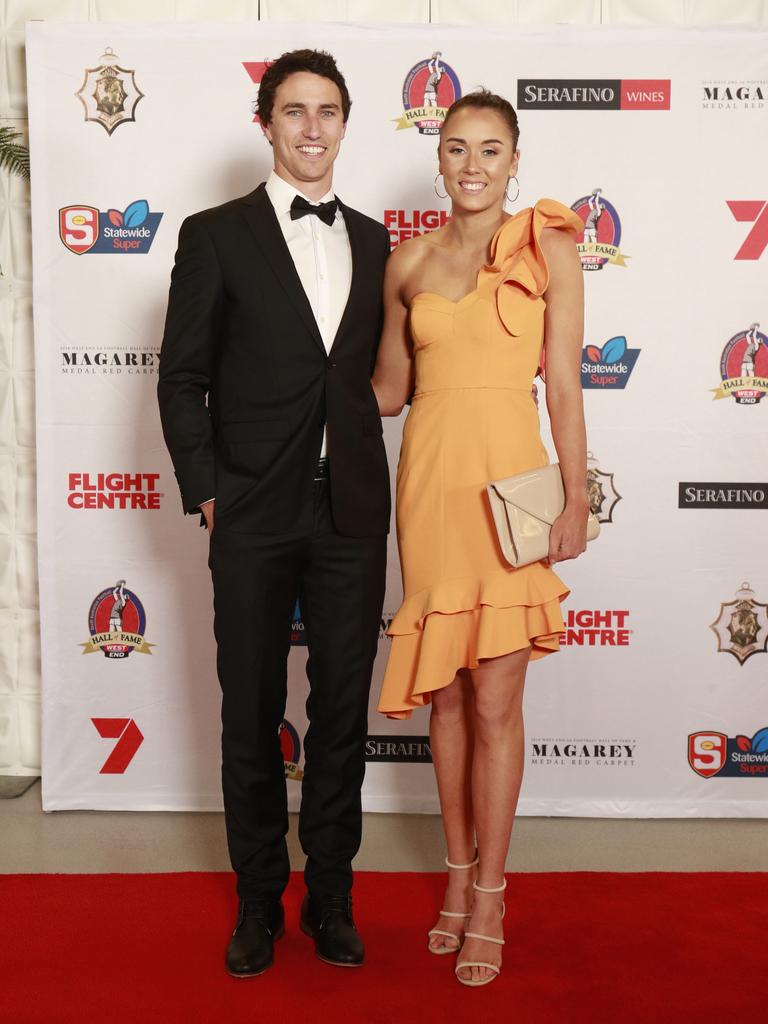 Tom Keough and Chelsea Lemke, wearing Bariano, pose for a picture on the red carpet at Adelaide Oval in North Adelaide, for the Magarey Medal, Monday, September 9, 2019. Picture: Matt Loxton