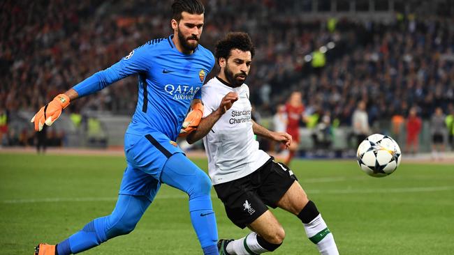 Roma's Brazilian goalkeeper Alisson (L) vies with Liverpool's Egyptian midfielder Mohamed Salah during the UEFA Champions League semi-final.