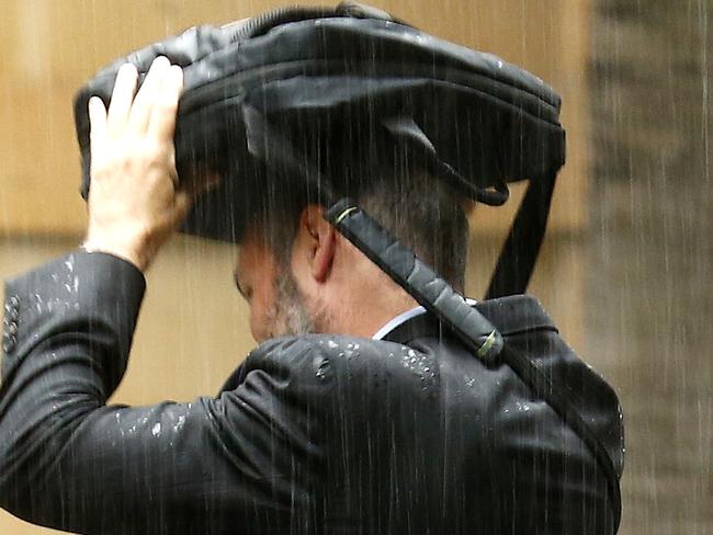 Wet weather outside the Governor Macquarie Tower, Sydney. Rain, umbrella, forecast, wet. Picture: Bradley Hunter