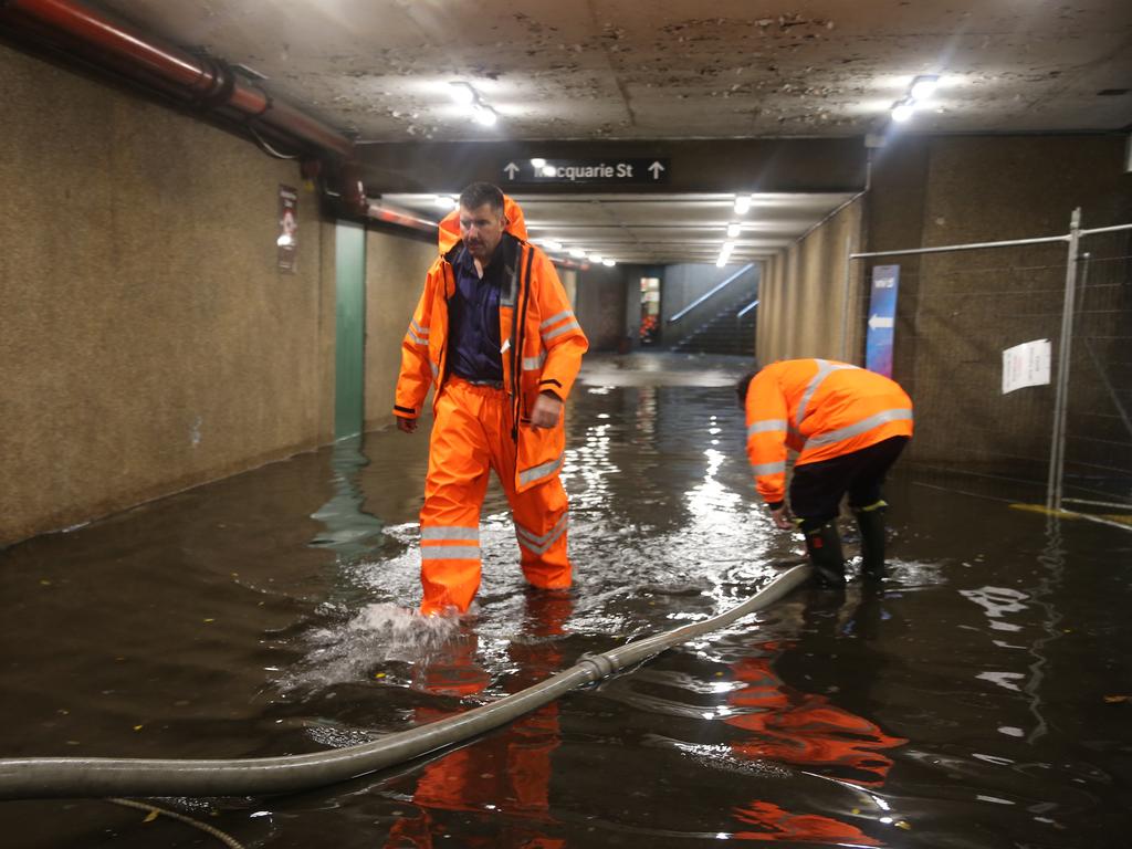 The Macquarie st exit of St. James station was flooded. Picture: John Grainger