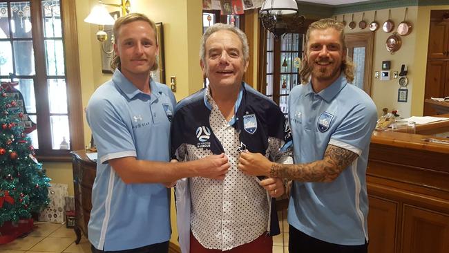 Sydney FC players Rhyan Grant, left, and Luke Brattan with Dr Stephen Gatt whose life was saved at Sydney’s game on January 4.