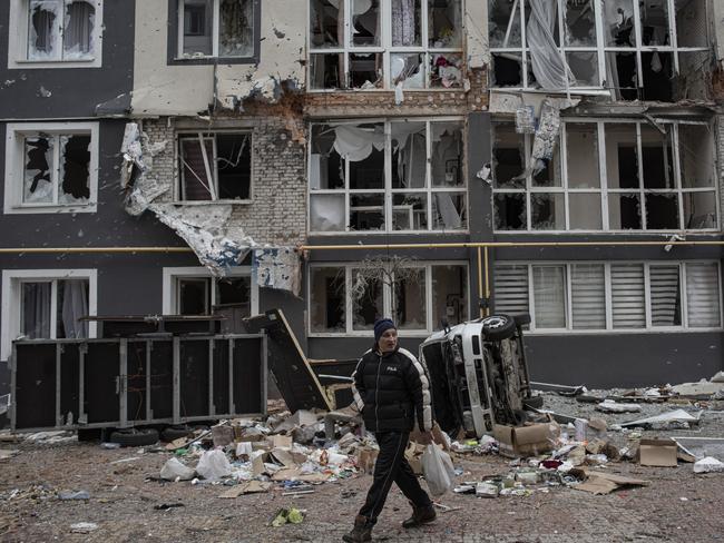A man walks past a heavily-damaged apartment building in Bucha. Picture: AFP
