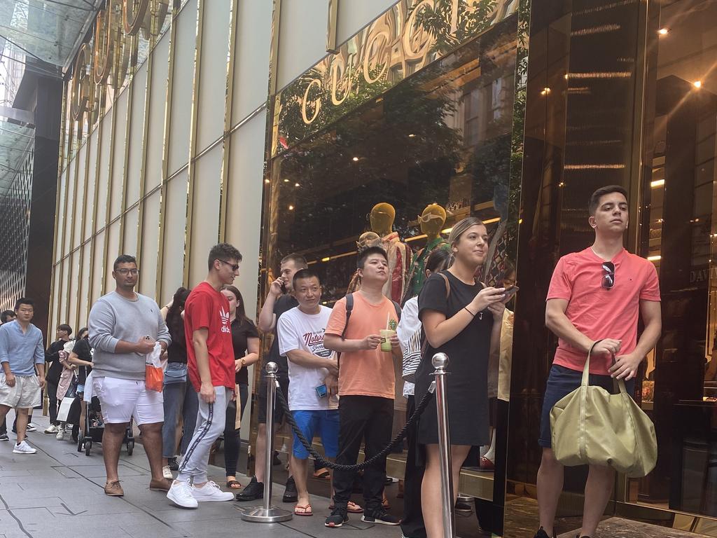 Shoppers patiently wait outside the Gucci store in Sydney. Picture: Rachel Lang