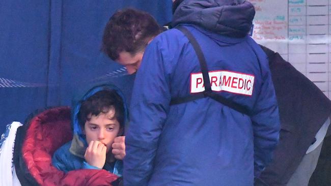 A paramedic treats the boy, two days after he went missing. Picture: AAP Image/James Ross