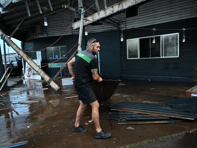 Grant McPherson from Maccas All Mechanical removes debris from his flood-affected Lismore business on March 2, 2022. Picture: Dan Peled