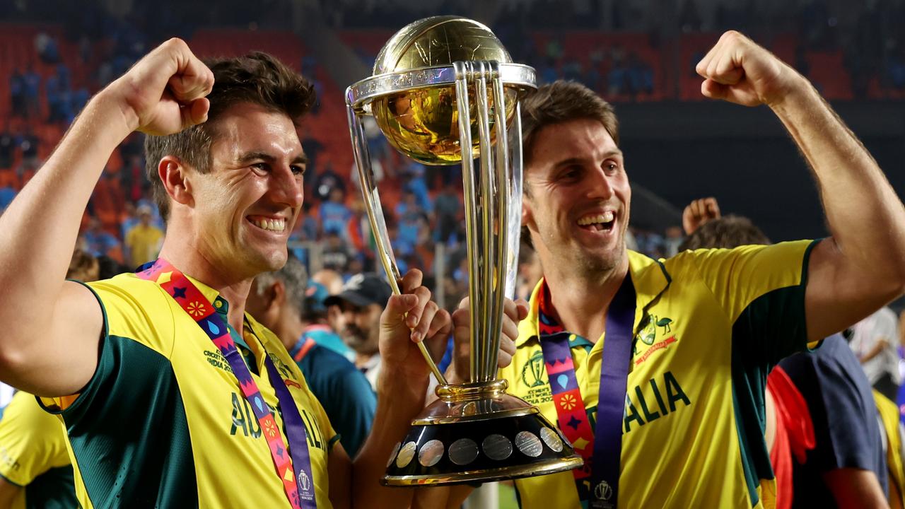 Mitch Marsh (right) celebrates with captain Pat Cummins and the World Cup trophy after Australia beat India in the final in Ahmedabad. Picture: Robert Cianflone / Getty Images