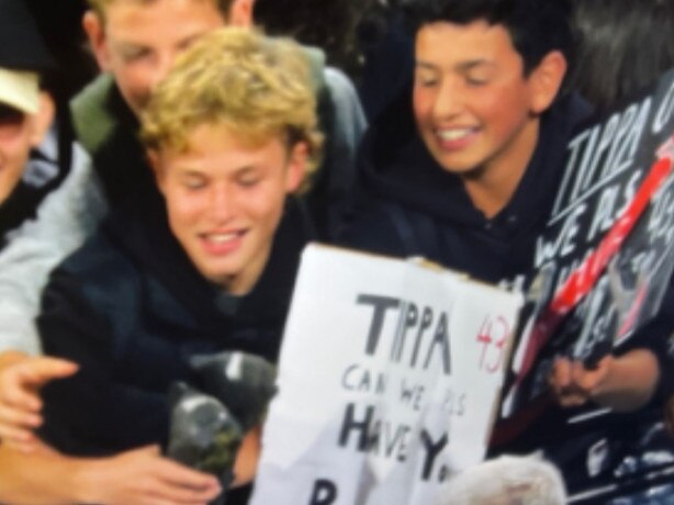 Bombers fans Billy White (holding Tippa's boots) and Sacha Demetriou (right). Picture: Channel 7