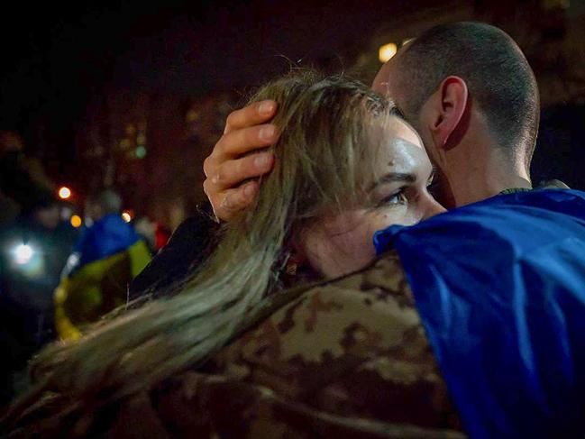 A Ukrainian prisoner of war embracing his wife after the exchange. Picture: AFP