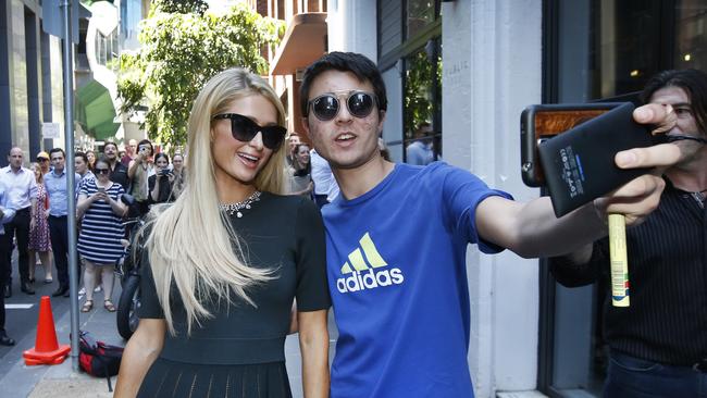 Paris Hilton taking a selfie with a fan after arriving at the Garden State Hotel, Melbourne. Picture: David Caird.