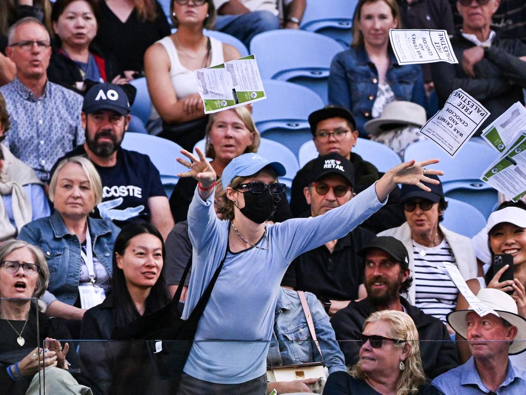 A pro-Palestinian protester throws leaflets onto the court during the men's singles match between Britain's Cameron Norrie and Germany's Alexander Zverev.