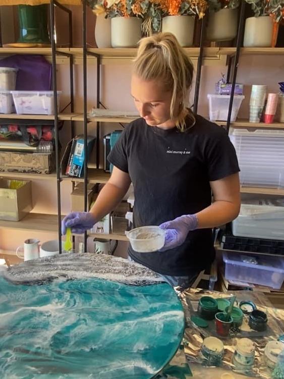 Ms Murray carefully layers the ashes on the artwork. Picture: Brielle Burns/news.com.au